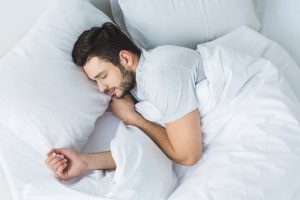 incontinent man in bed sleeping